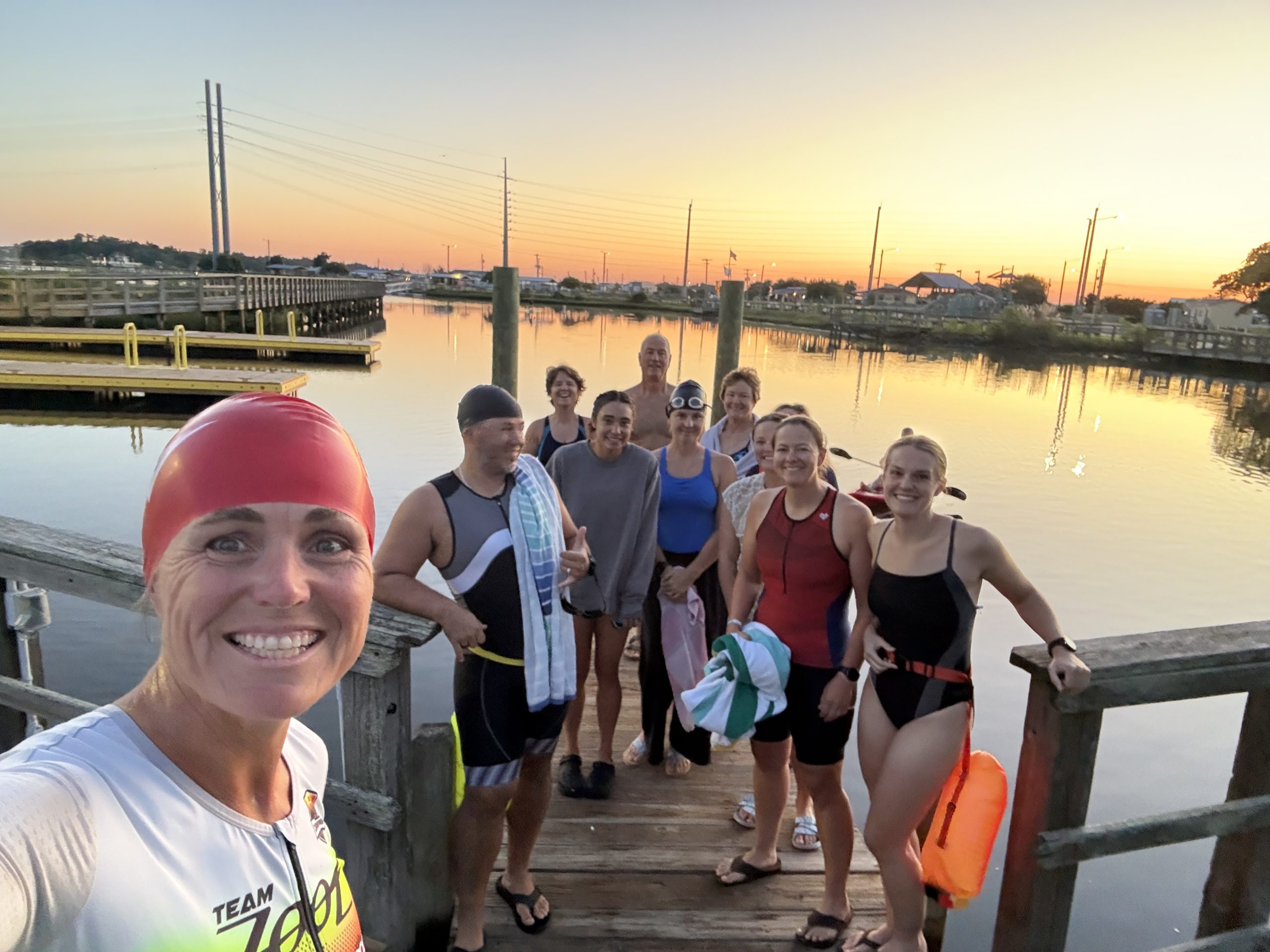 Group of beginner triathletes with coach Erin Byrge preparing for an open water swim training session